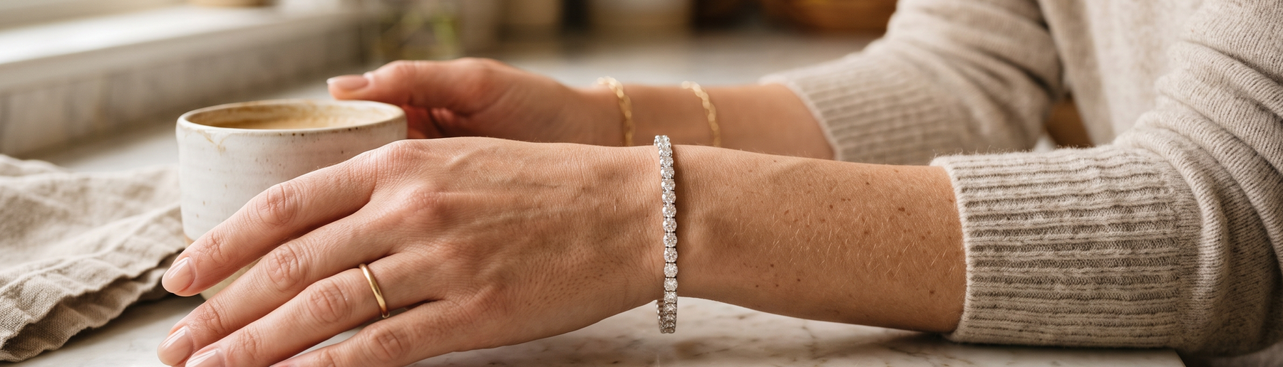 Woman's wrist wearing a lab-grown diamond tennis bracelet in natural light