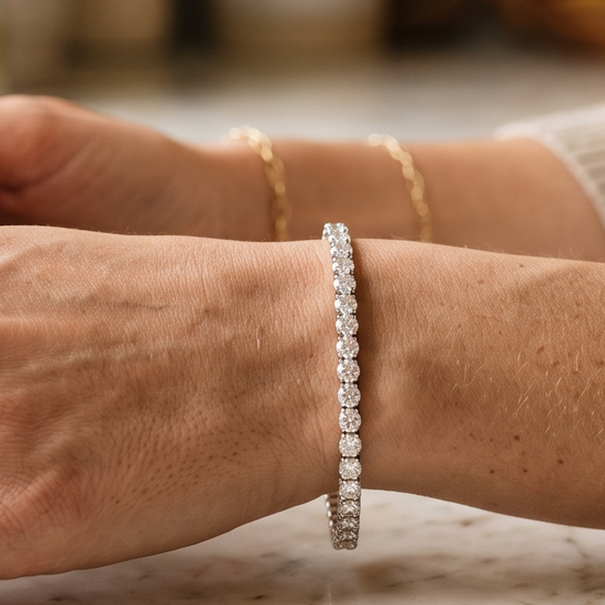 Woman's wrist wearing a lab-grown diamond tennis bracelet in natural light
