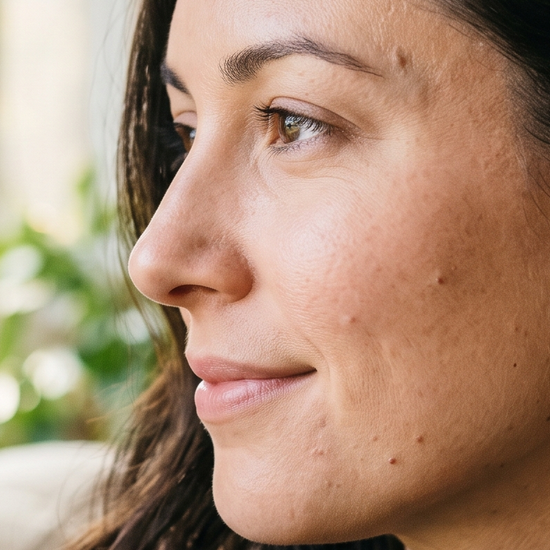 Woman wearing sparkling lab-grown diamond stud earrings in natural light