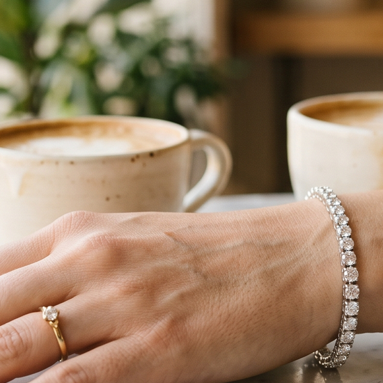 Woman's wrist wearing a sparkling lab-grown diamond tennis bracelet in natural light