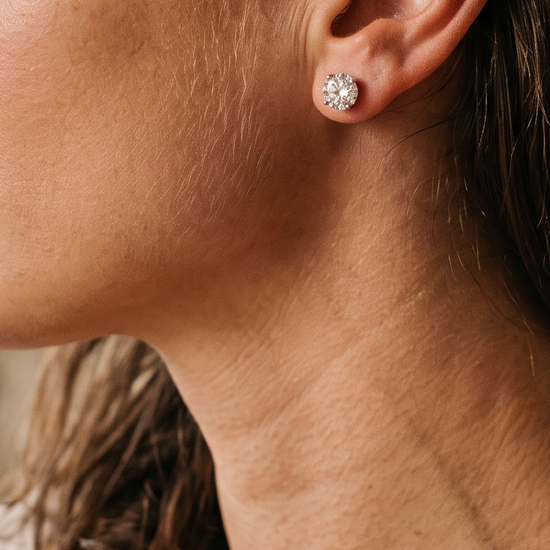 Close-up of a woman wearing lab-grown diamond stud earrings in natural light