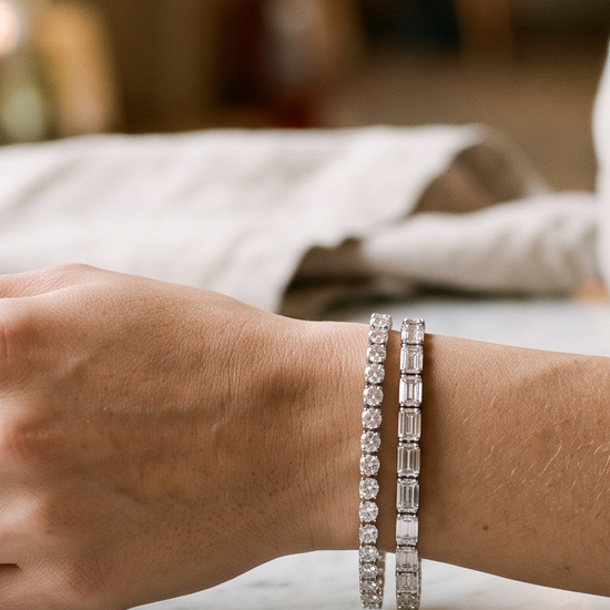 Woman's wrist wearing lab-grown diamond tennis bracelets in white gold and platinum in natural light
