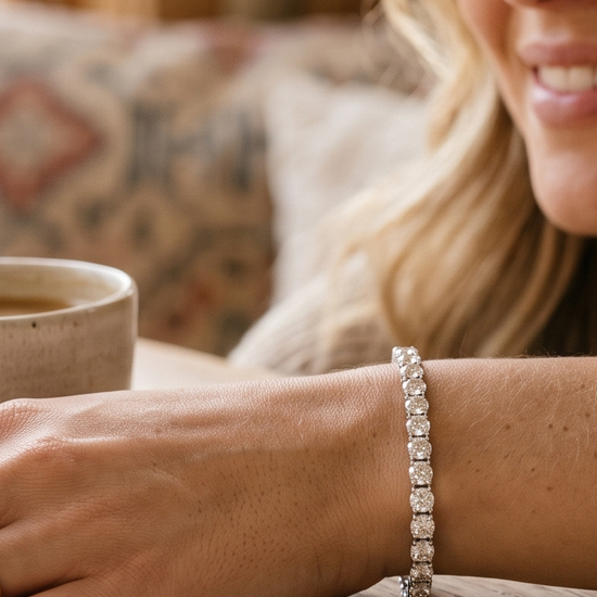 Woman's wrist wearing a lab-grown diamond tennis bracelet in natural light