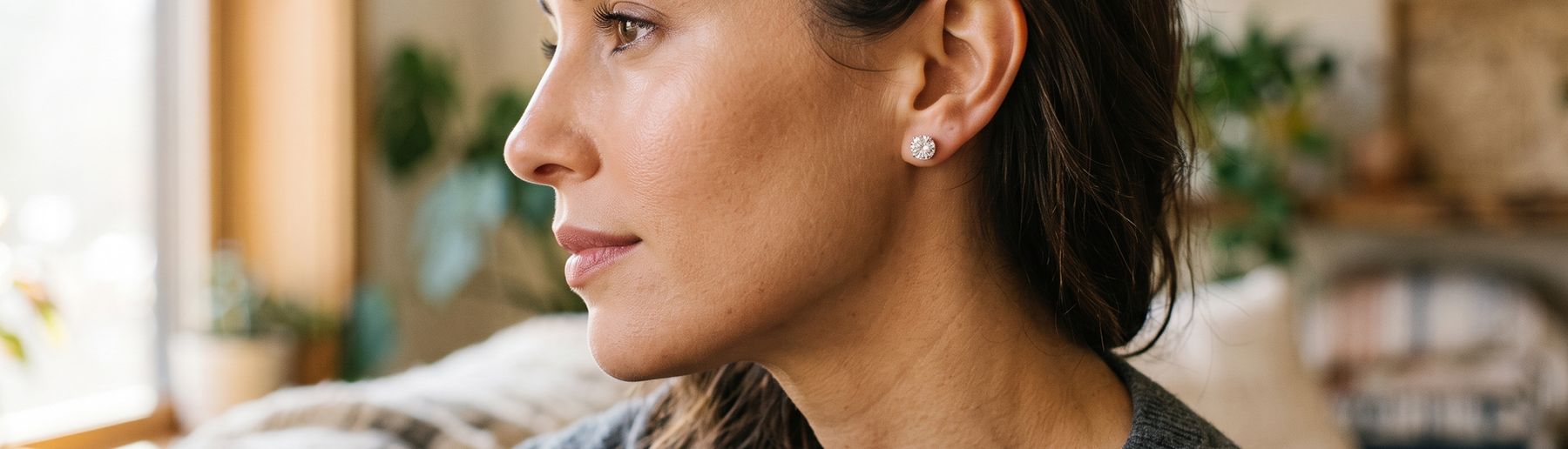 Woman wearing sparkling lab-grown diamond stud earrings in natural light