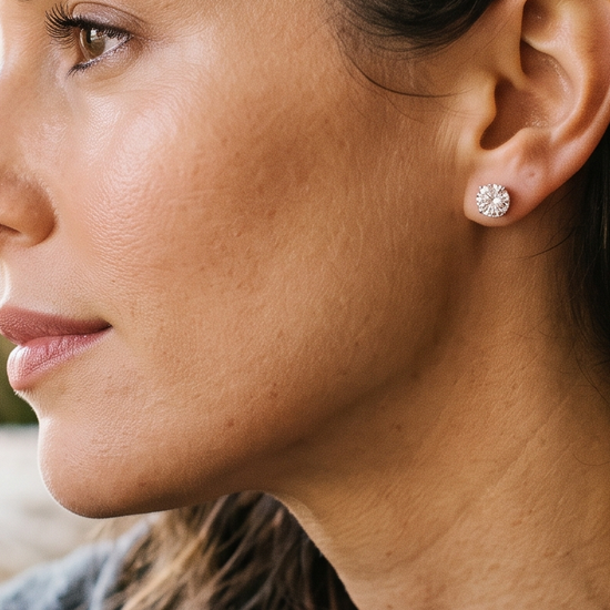 Woman wearing sparkling lab-grown diamond stud earrings in natural light