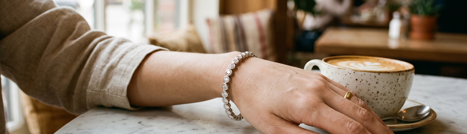 Woman's wrist wearing a lab-grown diamond tennis bracelet in natural light