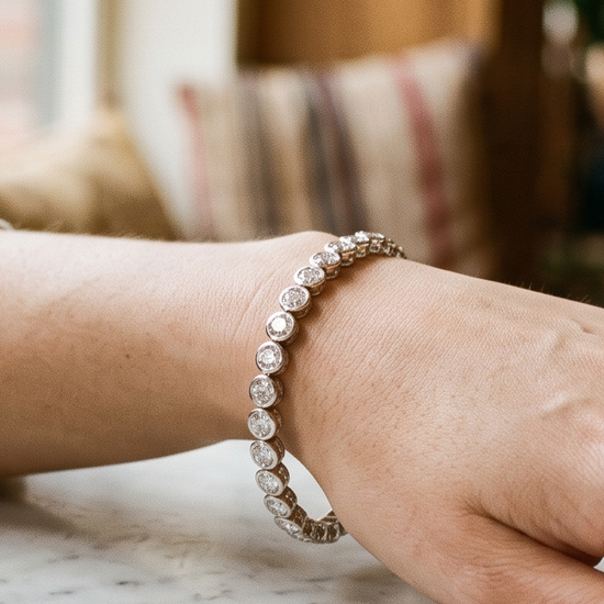 Woman's wrist wearing a lab-grown diamond tennis bracelet in natural light