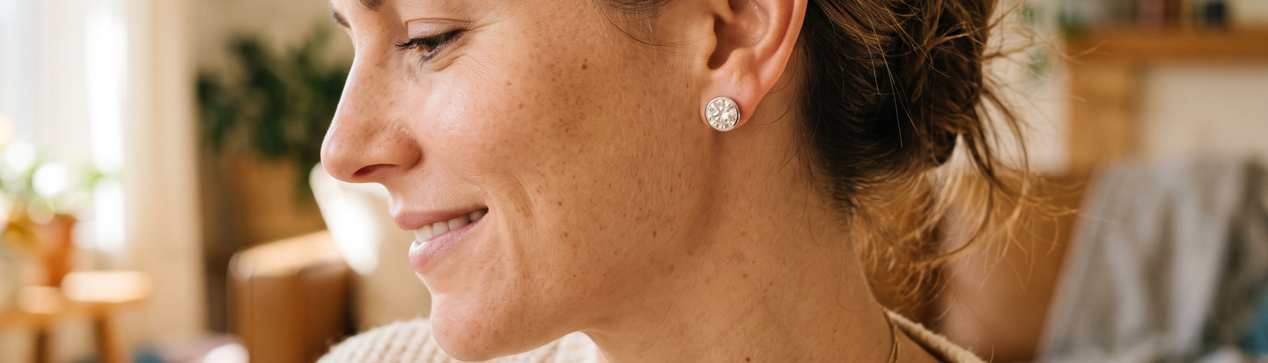 Close-up of a woman wearing lab-grown diamond stud earrings in natural light