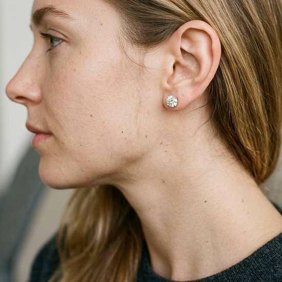 Woman wearing lab-grown diamond stud earrings in natural light