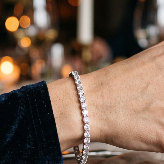 Woman's wrist wearing a sparkling lab-grown diamond tennis bracelet on a Valentine's Day date night