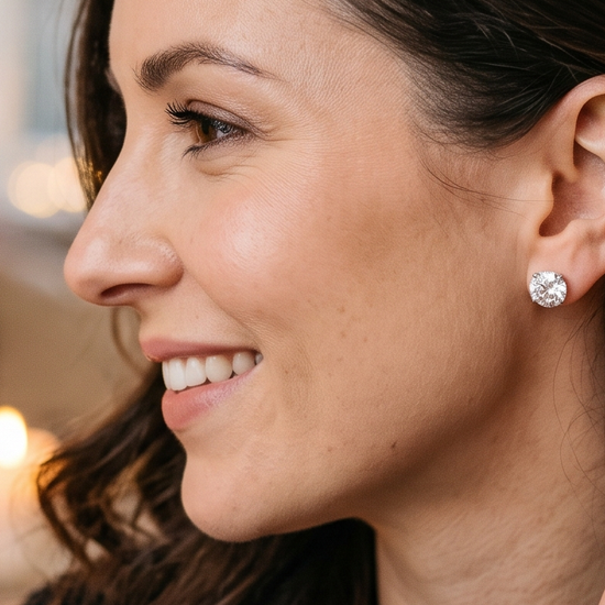 Woman tucking her hair back to reveal a sparkling lab-grown diamond stud earring, anniversary gift
