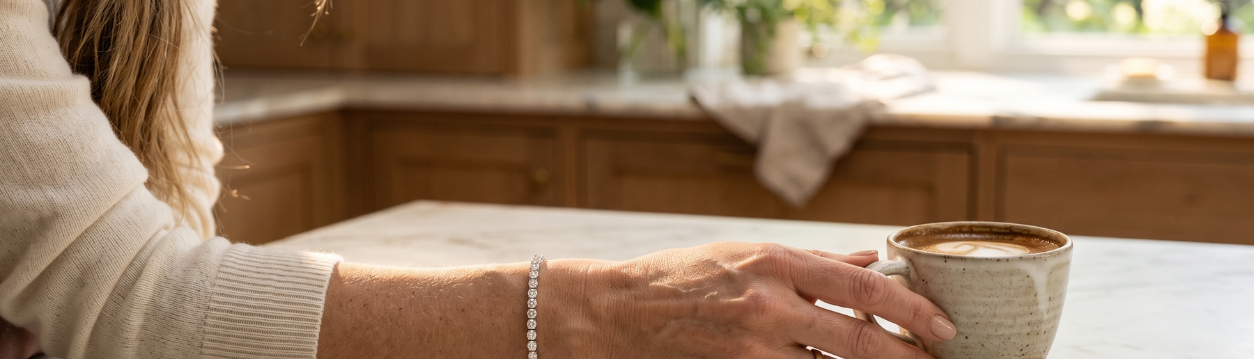 Woman's wrist wearing a lab-grown diamond tennis bracelet in natural morning light