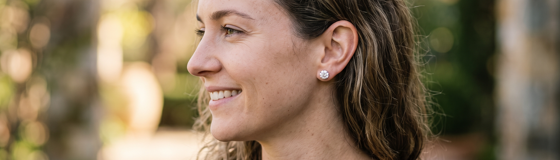 Woman wearing sparkling lab-grown diamond stud earrings