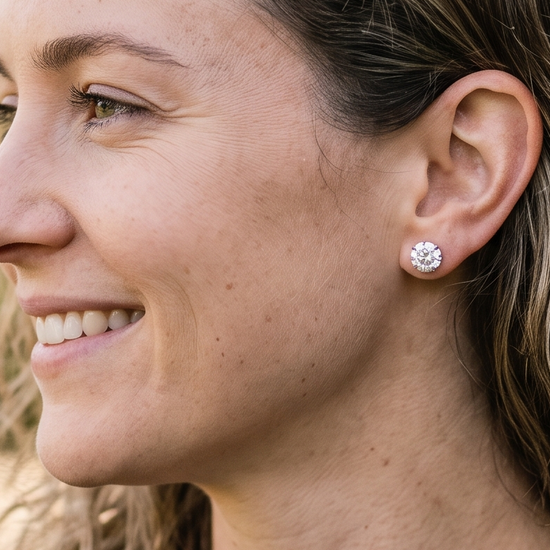 Woman wearing sparkling lab-grown diamond stud earrings