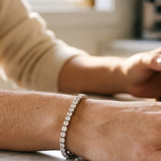 Woman wearing a lab-grown diamond tennis bracelet in natural morning light