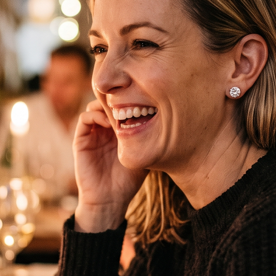 Woman wearing lab-grown diamond stud earrings while laughing at her 40th birthday celebration