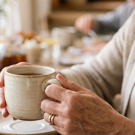 Woman's hands holding a mug while wearing a diamond tennis bracelet